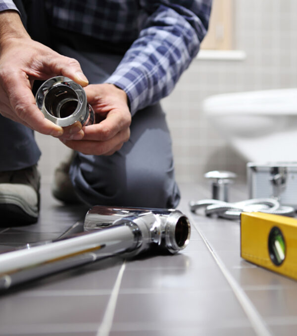 hands plumber at work in a bathroom, plumbing repair service, assemble and install concept