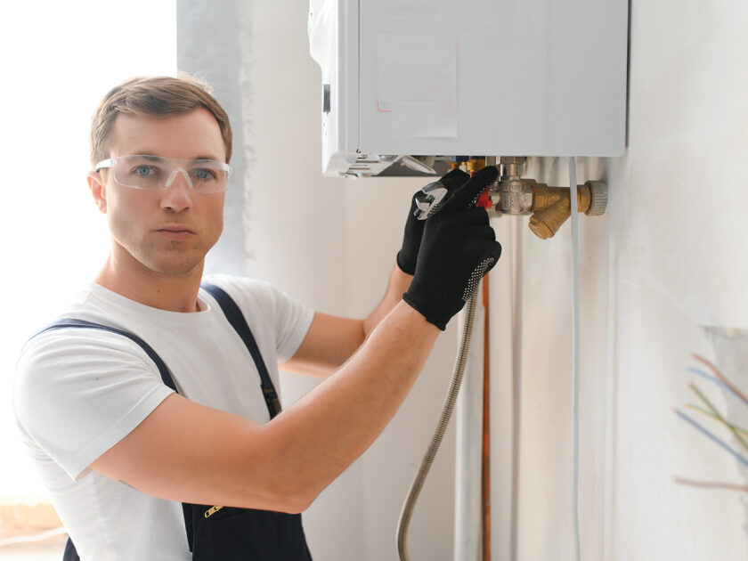 Young engineer adjusting autonomous heating.
